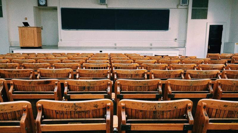 Empty Classroom With Wooden Chairs Lined up