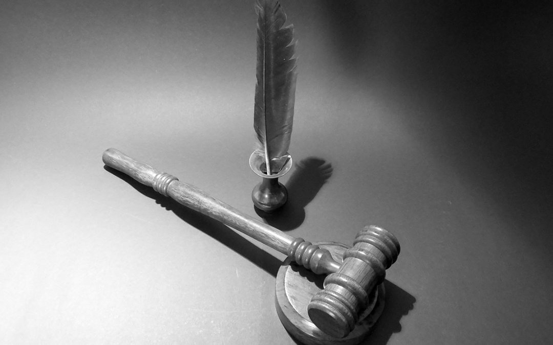 Balck and white image of gable and feather pen