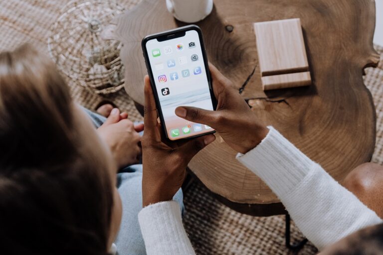 woman-holding-phone-looking-at-organic-social-media-apps