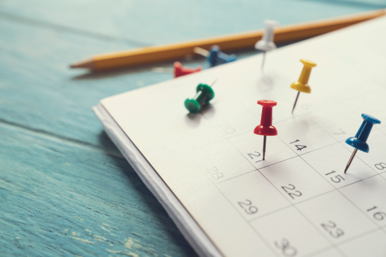 plotting-out-crucial-dates-for-q4-planning-on-a-calendar-with-pushpins
